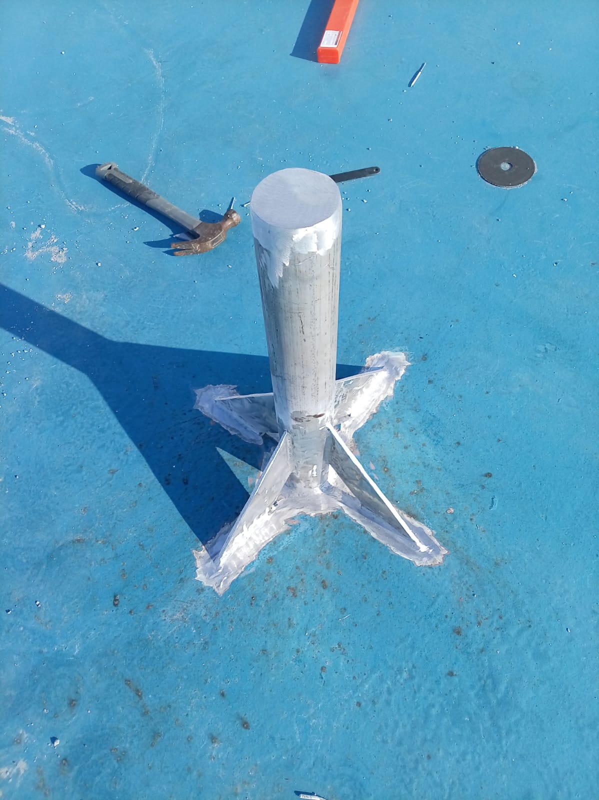 Custom welded aluminum pedestal support structure installed on a marine vessel deck