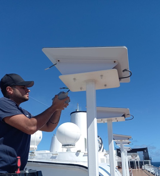 Technician installing a Starlink Flat High Performance marine satellite antenna on a CCL vessel.